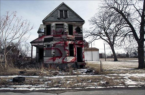 A vacant and blighted home, covered with red spray paint, sits alone in an east side neighborhood once full of homes in Detroit, Michigan.