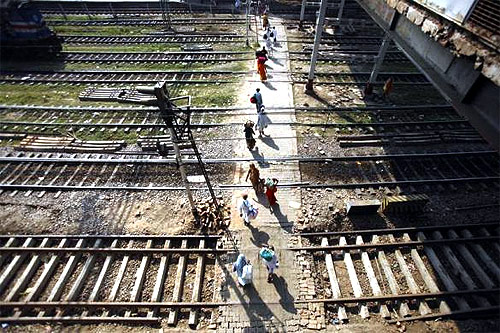 Commuters cross the tracks to reach the other side of the platform in Allahabad.