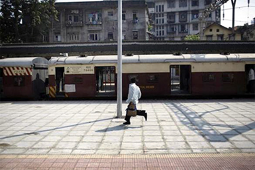 A man runs to catch a train at Dadar Railway Station in Mumbai.