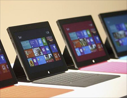 Surface tablet computers with keyboards are displayed at its unveiling by Microsoft in Los Angeles, California.