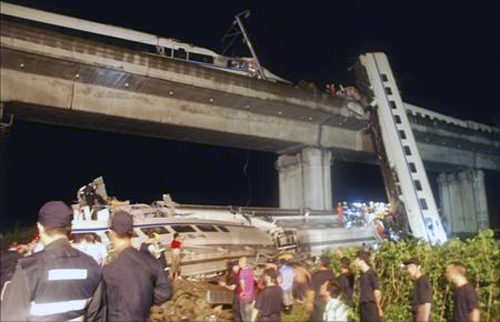 Rescuers carry out rescue operations after two carriages from a bullet train derailed and fell off a bridge in Wenzhou, Zhejiang.