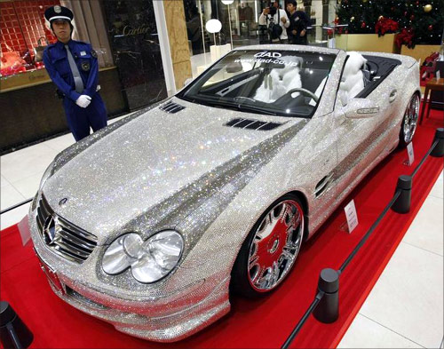A Mercedez-Benz SL600 series shimmering with Swarovski crystal glass is displayed as a security person stands guard at Sogo department store in Osaka.