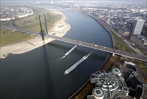 Ships pass the Rhine river with a partially dried-up riverbed in the western town of Dusseldorf.