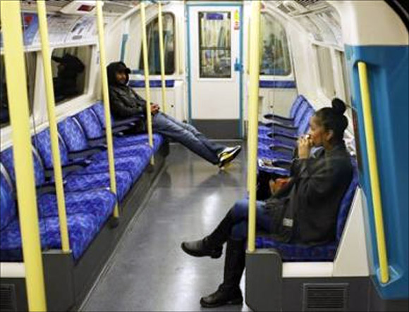 Passengers sit in an underground commuter train in London.