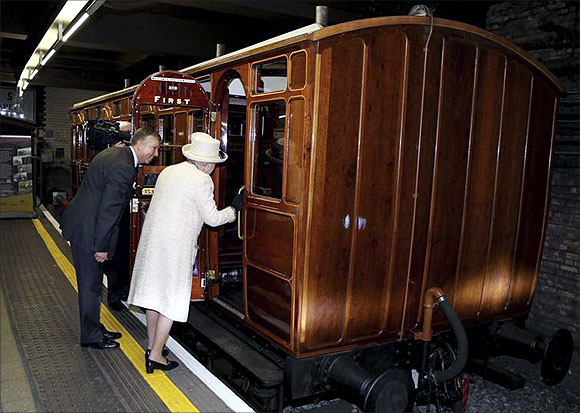 -Britain's Queen Elizabeth views a vintage carriage with Mike Brown, managing director of London Underground.