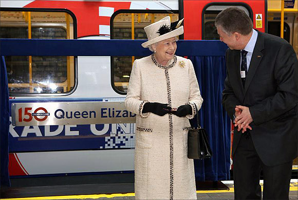 Britain's Queen Elizabeth speaks with Mike Brown, managing director of London Underground.