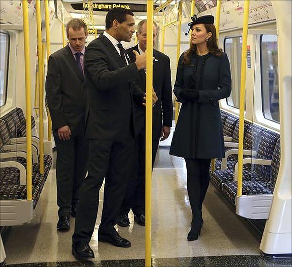 Britain's Catherine, Duchess of Cambridge (R) inspects a tube train during her visit to Baker Street underground station.