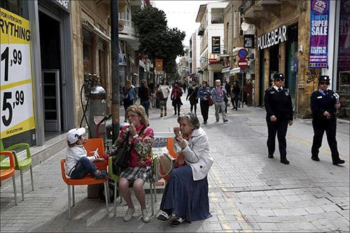 Two Cypriot policewomen patrol at a main market street of capital Nicosia.