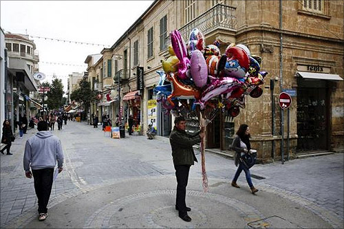 A man selling ballons stands in the middle of the market Ledras street in Nicosia.