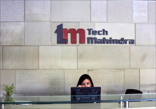 An employee sits at the front desk inside Tech Mahindra office building in Noida on the outskirts of New Delhi.