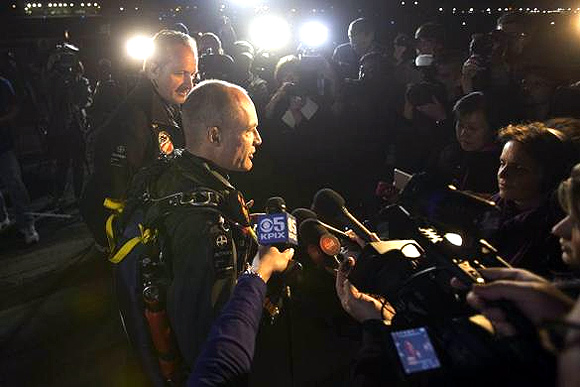 Solar Impulse pilots Andre Borschberg (L) and Bertrand Piccard speaks to members of the media before Bertrand takes off from Moffett Field to begin the first leg of their 2013 Across America Mission in Mountain View, California.