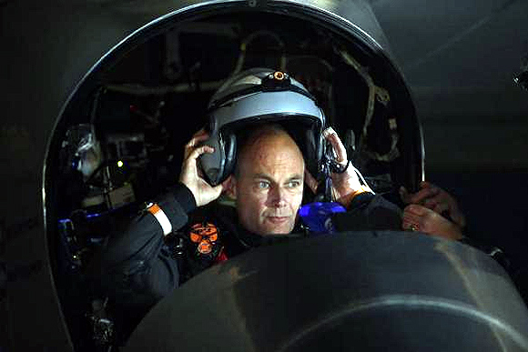 Solar Impulse pilot Bertrand Piccard puts on his flight helmet before taking off from Moffett Field to begin the first leg of his 2013 Across America Mission in Mountain View, California.