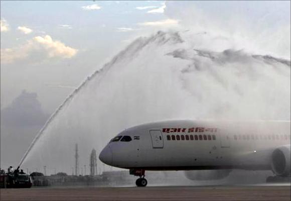 Air India's Dreamliner Boeing 787 is given a traditional water cannon salute by the fire tenders upon its arrival at the airport in New Delhi.