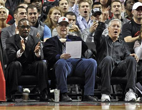 Portland Trail Blazers owner Paul Allen (C) watches game with Seattle Seahawks coach Pete Carroll (R) and Trail Blazers president Larry Miller (L) during first quarter of NBA basketball game against the Utah Jazz in Portland, Oregon, in this April 18, 2012 file photo.