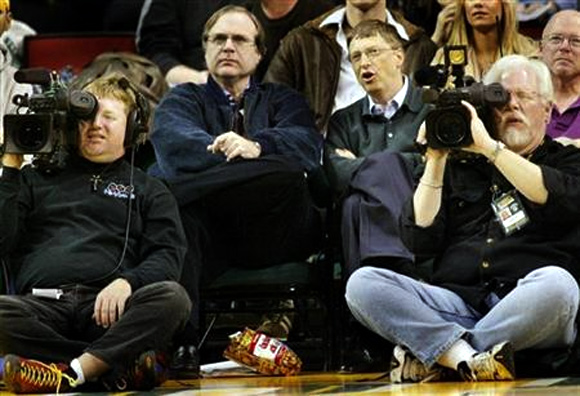 Microsoft co-founders Bill Gates and Paul Allen watch an NBA game at Key Arena in Seattle.
