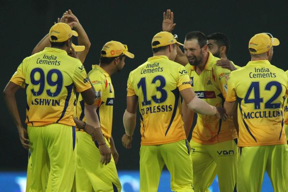 Chennai Super Kings players celebrate at the fall of a wicket