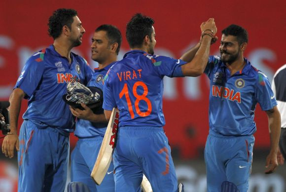 Mahendra Singh Dhoni celebrates with teammates after India beat South Africa in the second semi-final of the World T20 