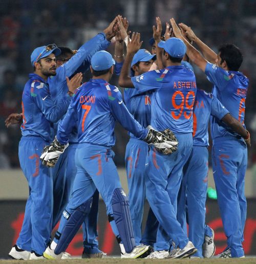 Indian players celebrate after picking a wicket 