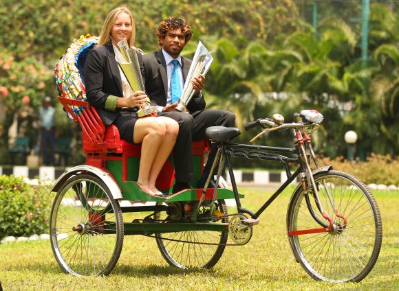 Meg Lanning, captain of Australia and Lasith Malinga, captain of Sri Lanka pose with the trophies on a rickshaw 