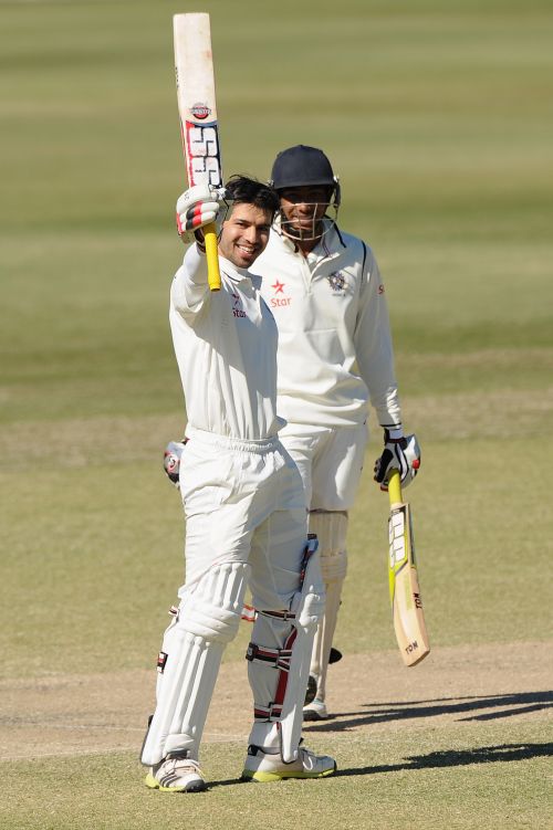 Naman Ojha celebrates after completing his century