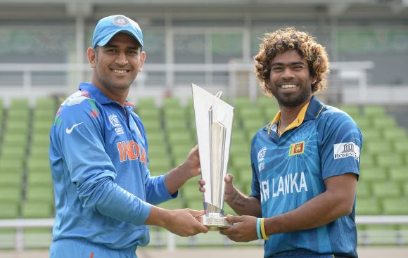 Mahendra Singh Dhoni and Lasith Malinga pose with the WT20 trophy before the final.