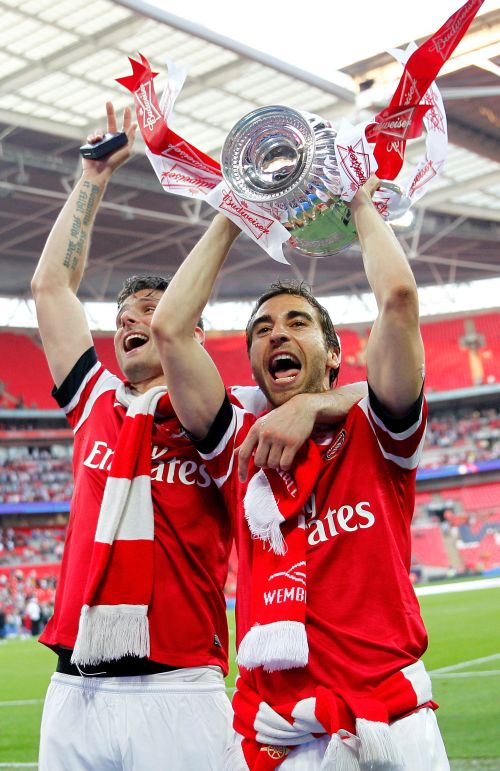 Olivier Giroud and Mathieu Flamini of Arsenal celebrate victory with the trophy after the FA Cup
