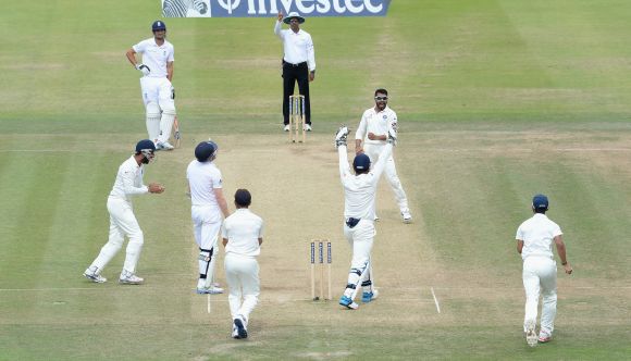 Ravindra Jadeja of India celebrates taking the wicket of Sam Robson of England 