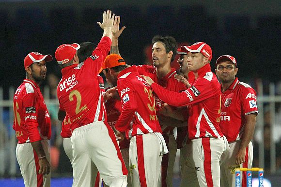 Kings XI players celebrate after picking up a wicket 