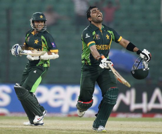 Umar Akmal celebrates after completing his century