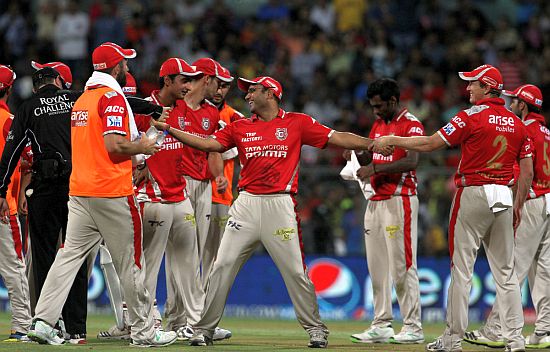Virender Sehwag celebrates with teammates after winning the game