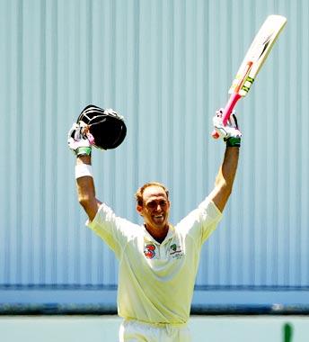 Mathew Hayden celebrates after completing his century.