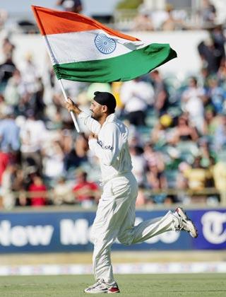 Harbhajan Singh celebrates with the tricolour after the win in Perth