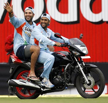 Dhoni taking Yuvraj for a ride on a bike