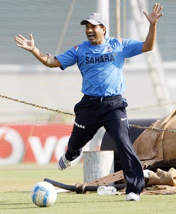 India's Sachin Tendulkar reacts while playing soccer during a training session in Mumbai