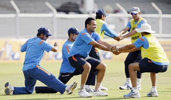 India's captain Dhoni, teammates Laxman, Khan, Singh and Dravid stretch during a training session in Mumbai