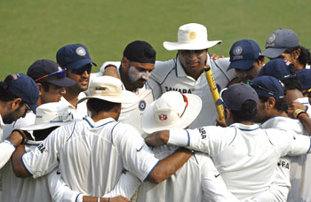 The Indian team get into a huddle after the victory
