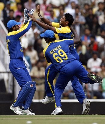 Sri Lanka players celebrate the dismissal of Sehwag