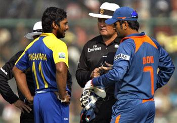Kumar Sangakkara and M S Dhoni in discussion with the umpires