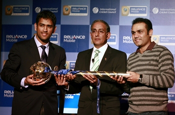 ICC chief Haroon Lorgat presents the Test Championship mace to Mahendra Singh Dhoni and Virender Sehwag