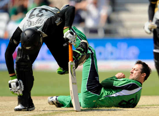 Martin Guptill makes his ground as Ireland's Alex Cusack makes a vain attempt to run him out