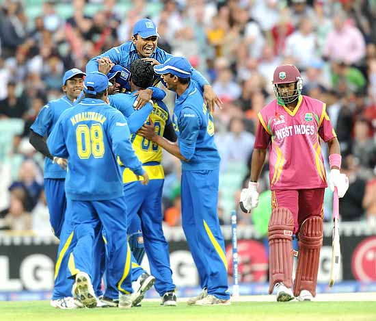 Angelo Mathews is swamped by his teammates after bowling Dwayne Bravo for a duck