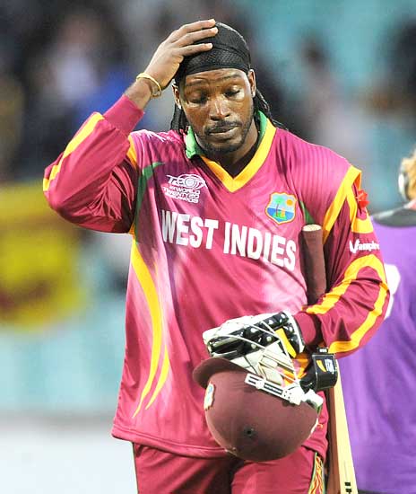 Chris Gayle walks back dejectedly after the end of the game