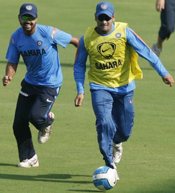 Indian captain MS Dhoni plays soccer with teammate Murali Vijay in Ahmedabad