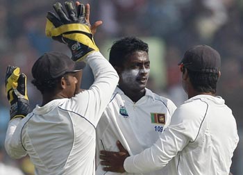 Ajantha Mendis being congratulated by his teammates
