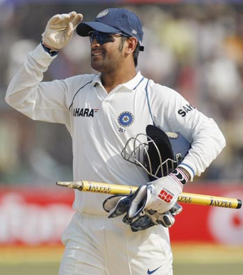 India's captain MS Dhoni walks off field after they won their second test cricket match against Sri Lanka in Kanpur