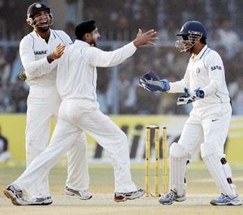 India's Harbhajan Singh celebrates taking the wicket of Sri Lanka's captain Sangakkara in Kanpur