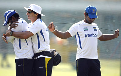 Sangakkara (right) stretches as physio Tommy Simsek assists Jayawardene during a training session on Monday