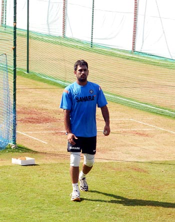 Captain MS Dhoni prepares to roll his arm in the nets