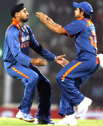 Harbhajan Singh celebrates with Suresh Raina after claiming the wicket of Cameron White