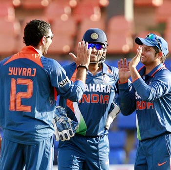 Yuvraj Singh (left) celebrates taking the wicket of Neil Broom